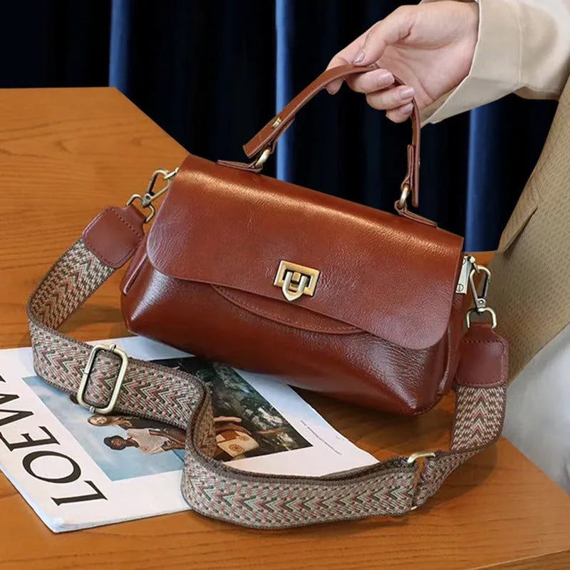Women's dark brown genuine leather saddle back handbag with double shoulder straps showing internal organisation compartments