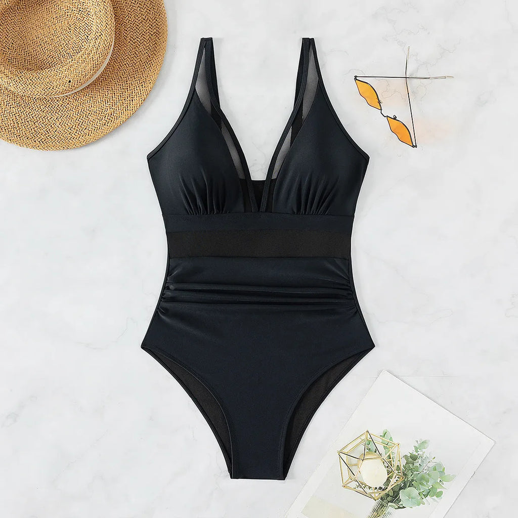 Black women's one-piece halter swimsuit with mesh detailing and brief-style bottom.