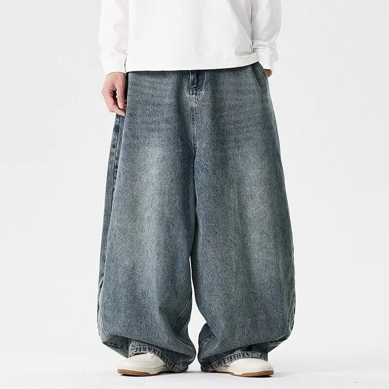 Men's loose fit plus size jeans in dark blue denim showing wide leg and low waist style.