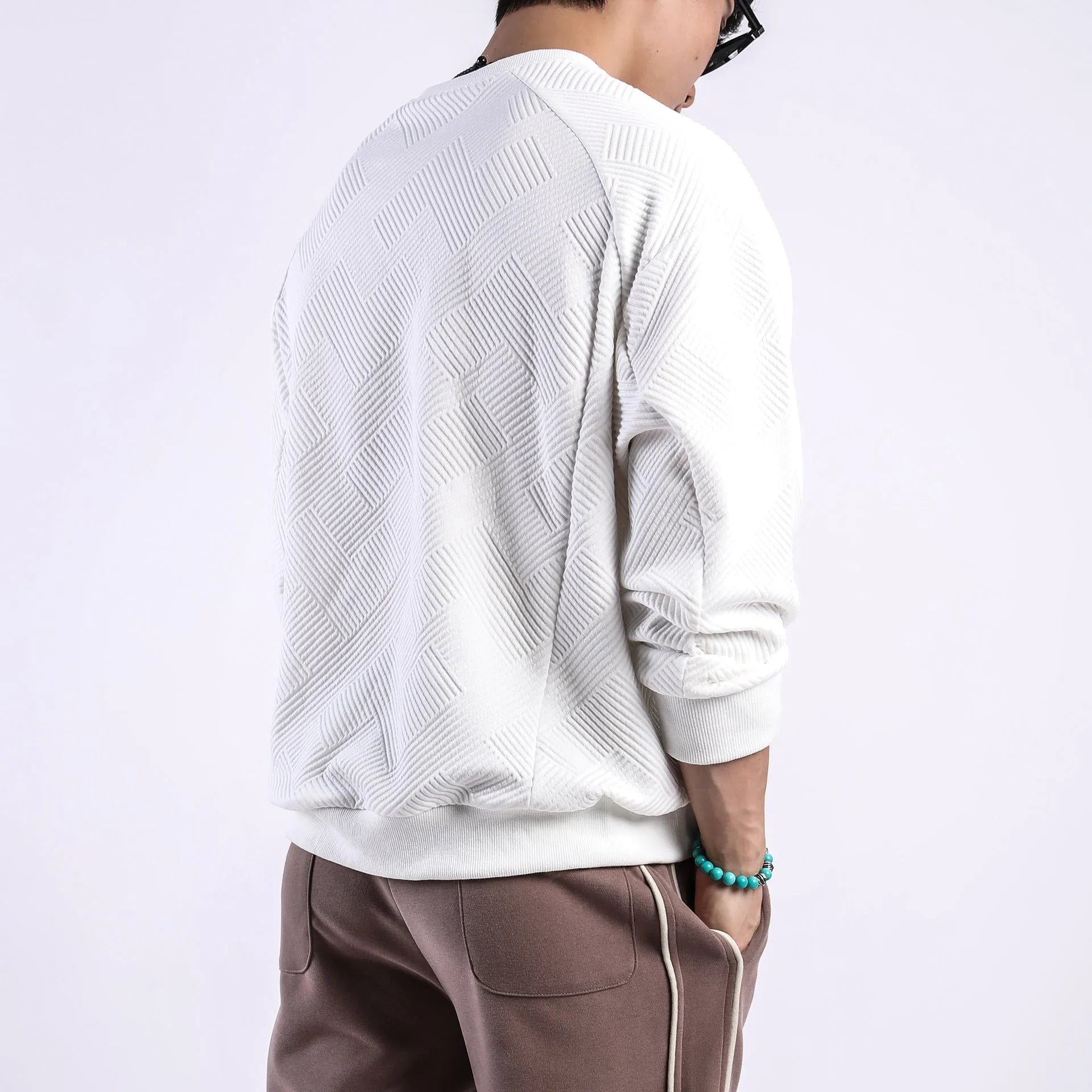 Men's loose long-sleeved sweater in twill jacquard fabric, shown in Army Green colour with a round neck.