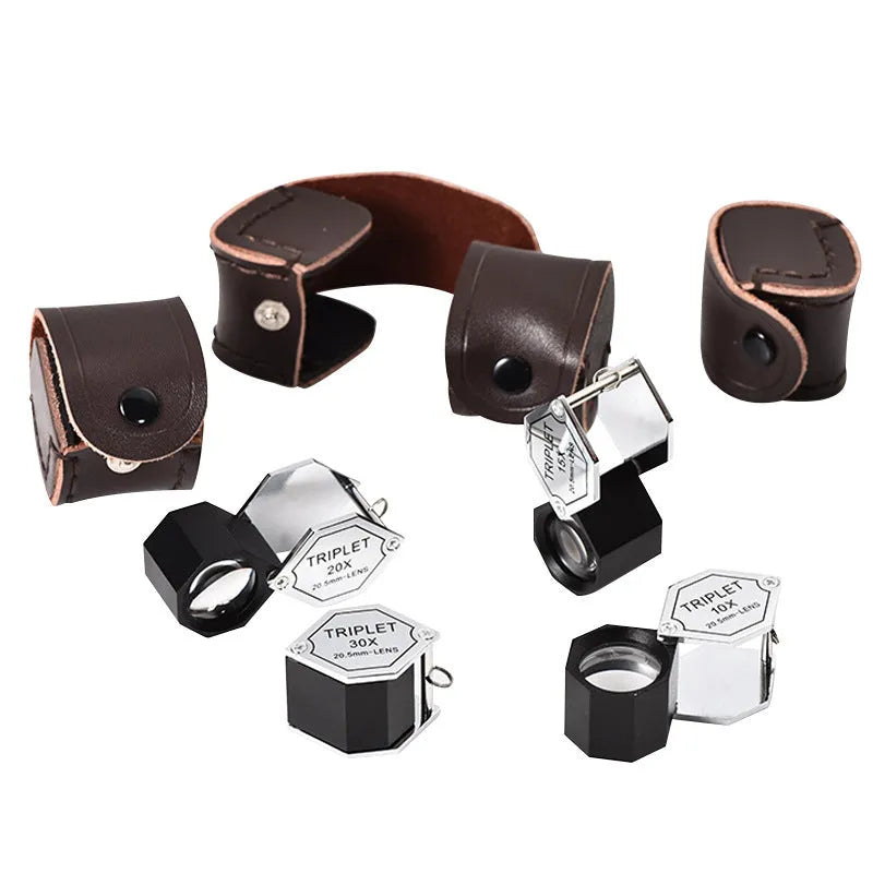 Handheld portable magnifying glass with metal body and optical glass lens for jewellery and coin inspection.