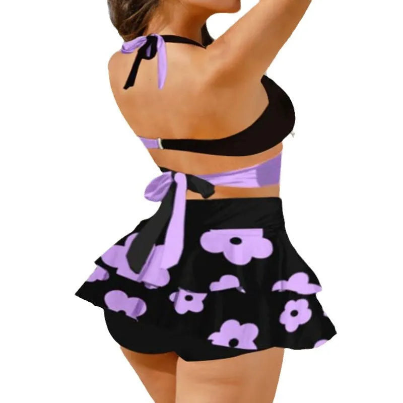 Women's purple bikini swimsuit with matching skirt showing lace-up detail and high waist briefs style