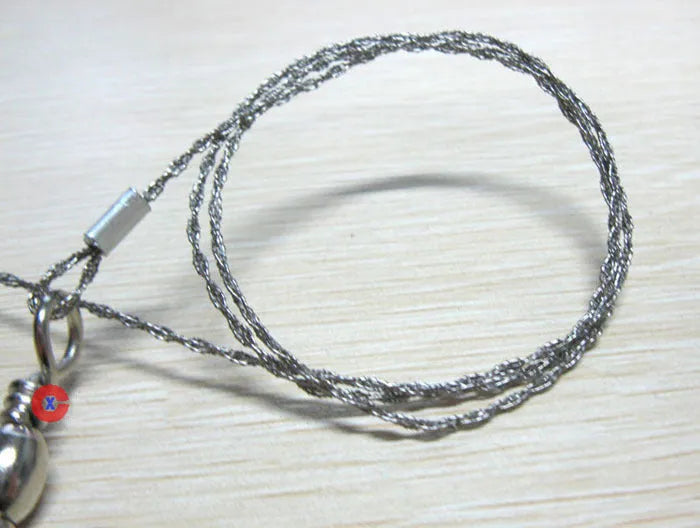 Stainless steel survival wire saw with thumb rings measuring 55cm cutting length