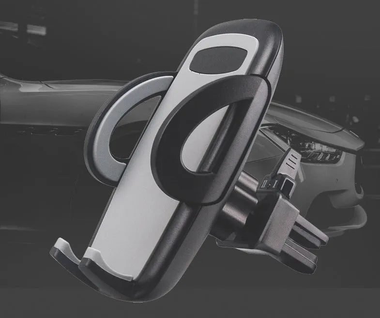 Black plastic mobile phone holder attached to car air conditioning outlet for hands-free navigation