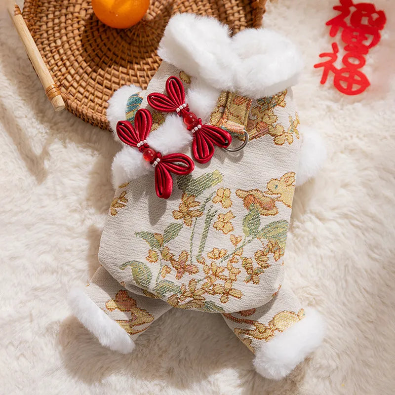 Lunar New Year brocade pet jumpsuit with faux fur trim, Chinese knot buttons and floral-gold motifs in red or beige.