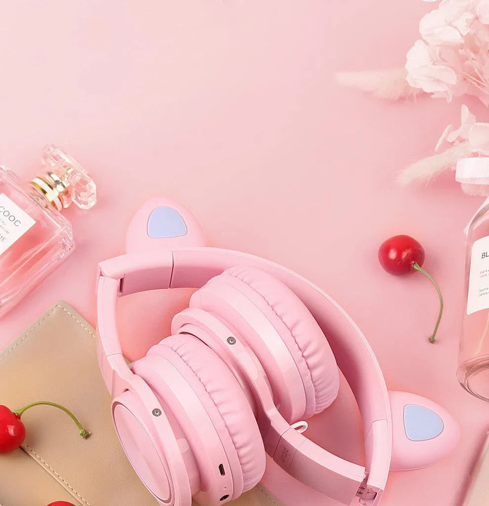 Pink-white wireless Bluetooth headset with head-mounted design and 40mm speakers