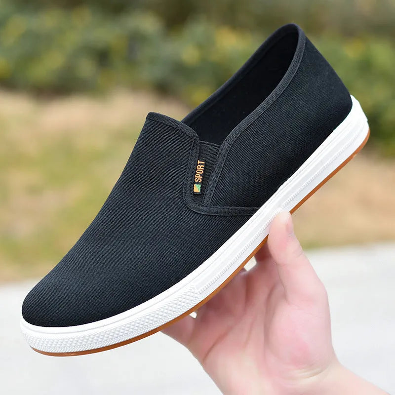 Men's black and blue canvas slip-on shoes with round toe and low-top design on composite sole