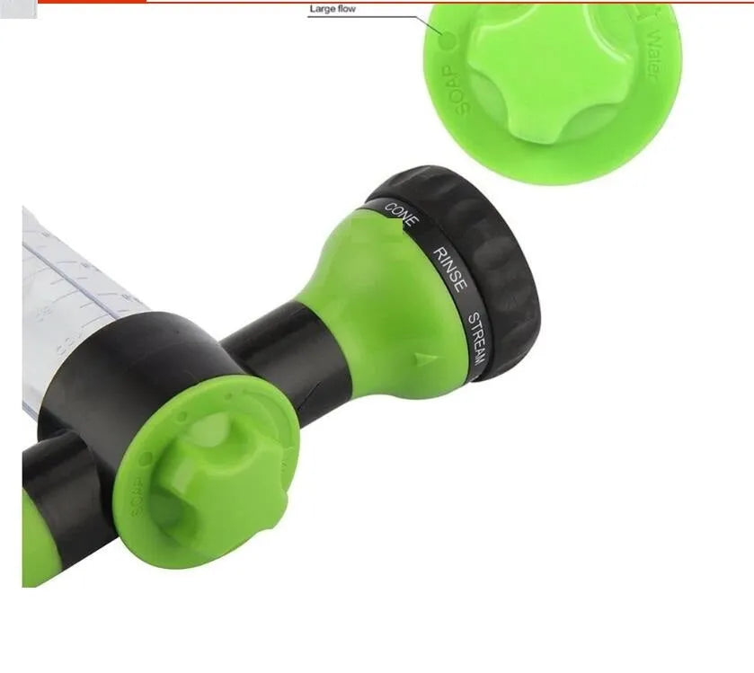 Green high-pressure foam spray gun with adjustable nozzle and attached water hose for car and garden cleaning.