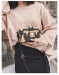 Women's hard PU shoulder bag with flap closure and single adjustable strap in black or green