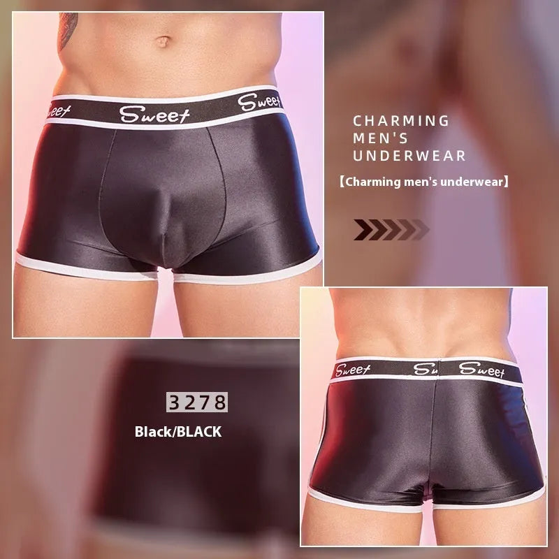 Man's silky shiny boxer shorts in black, white, and sapphire blue colours laid flat.