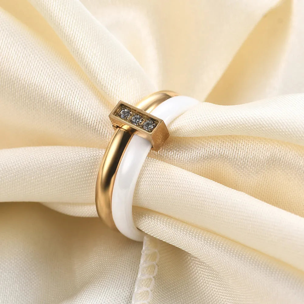 Ceramic women's ring with 6mm band width and inlaid zirconium accents in geometric round design