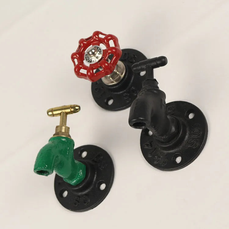 Metal water pipe style towel rack hook in modern design mounted on a wall.