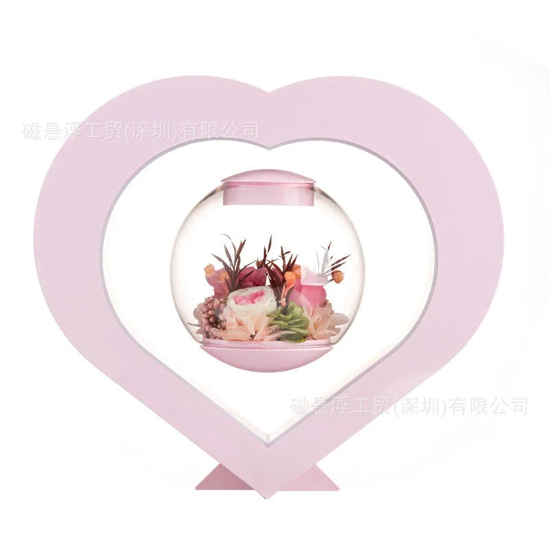 Pink preserved rose inside clear acrylic heart ornament with optional Bluetooth speaker base