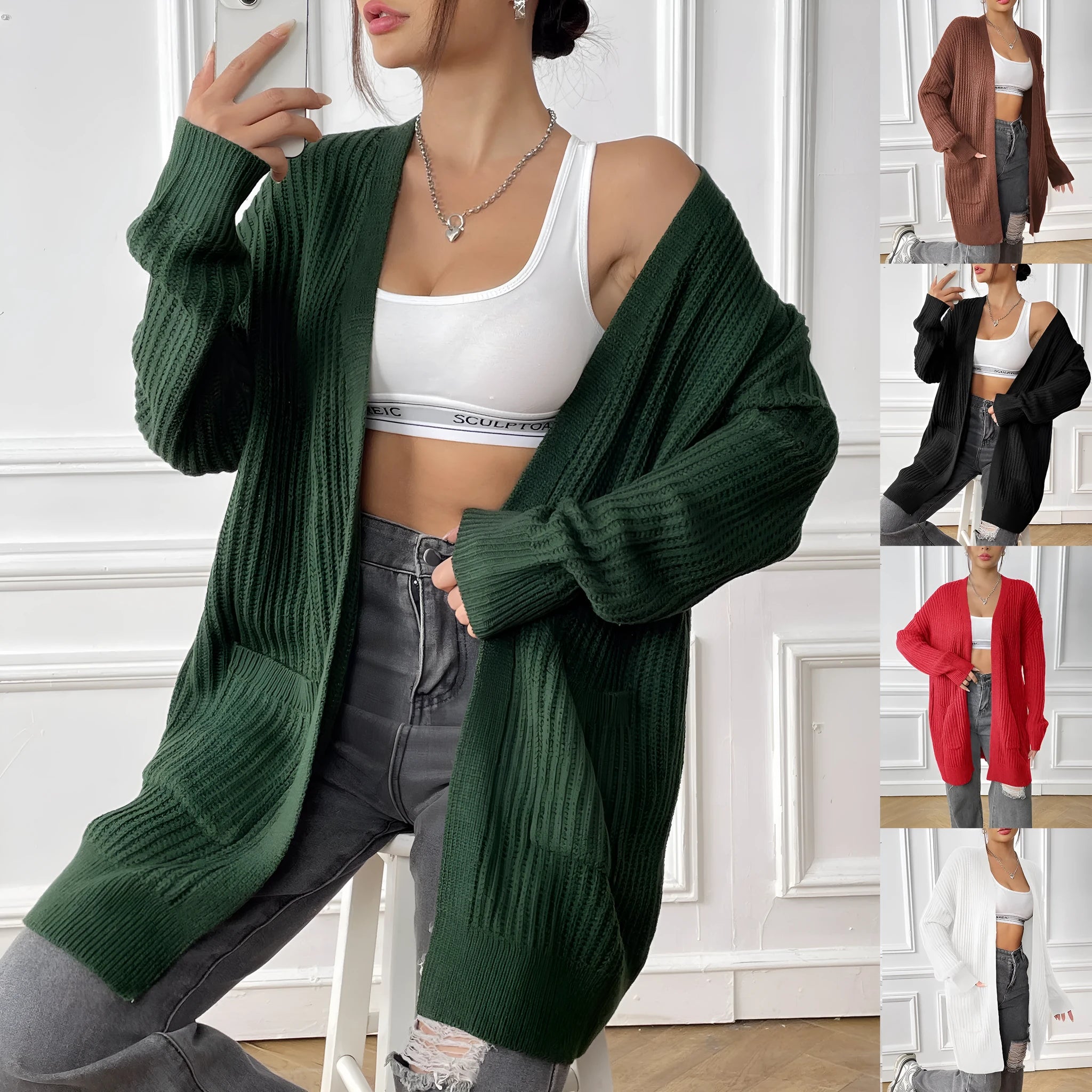 Women's dark green loose-fit mid-length acrylic cardigan sweater on a hanger.