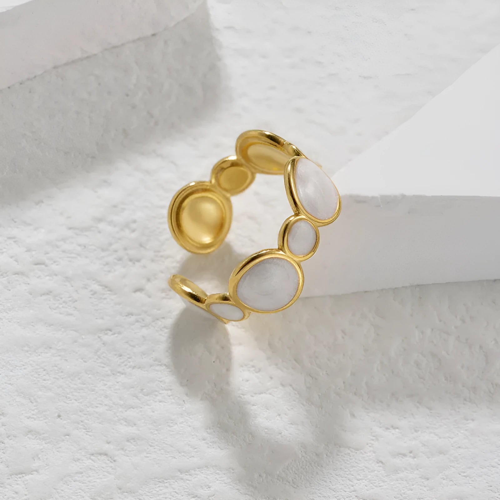 A geometric-shaped adjustable ring made from stainless steel with an electroplated metallic finish.