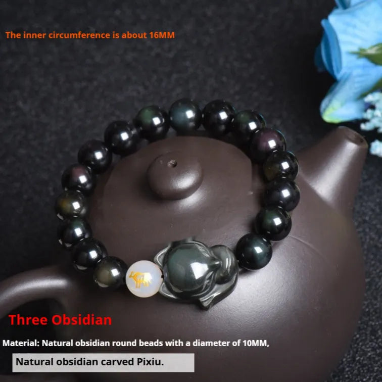 Adjustable obsidian zodiac bracelet with 10mm beads on a wrist.