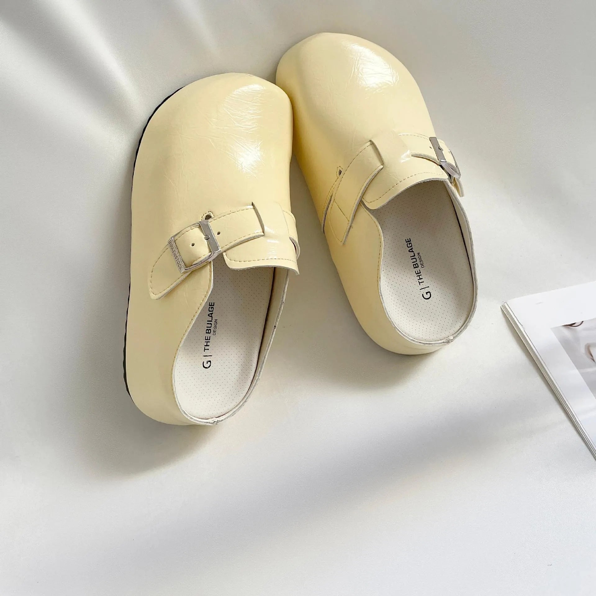 Flat casual sneakers with a buckle fastening and round toe in multiple colour options.