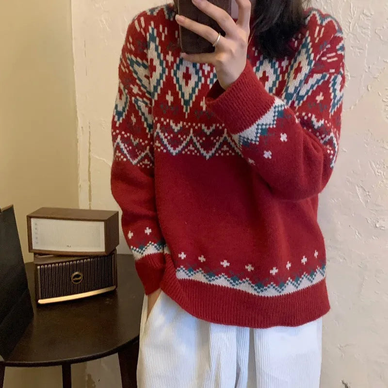 Red and white striped loose fit long sleeve knitted pullover top on a hanger.