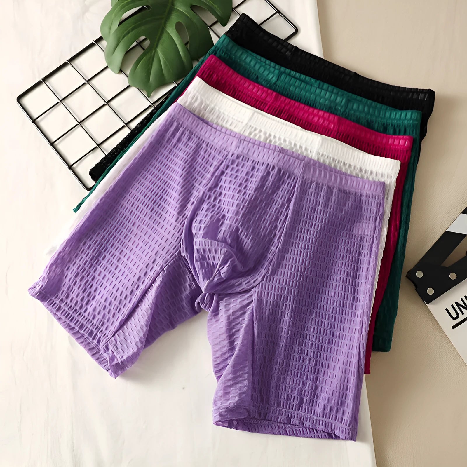 Men's solid colour lace boxer shorts in a lengthened, hip-lifting design on a white background.