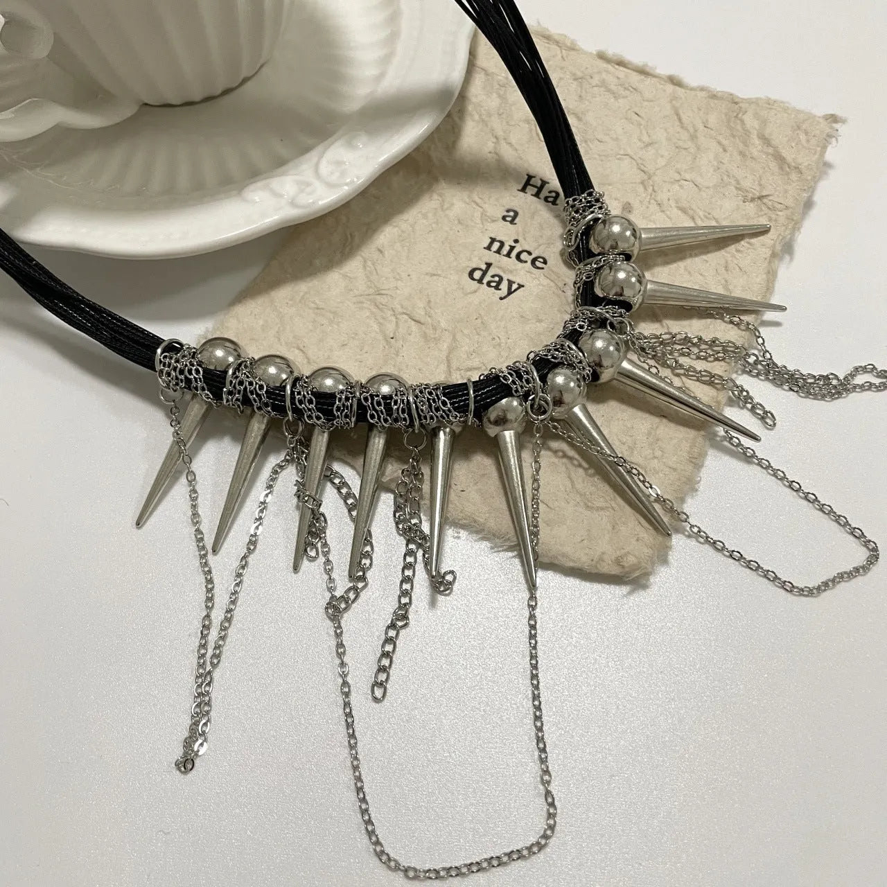 Women's leather necklace with winding tassel, round beads, and point rivets in electroplated finish