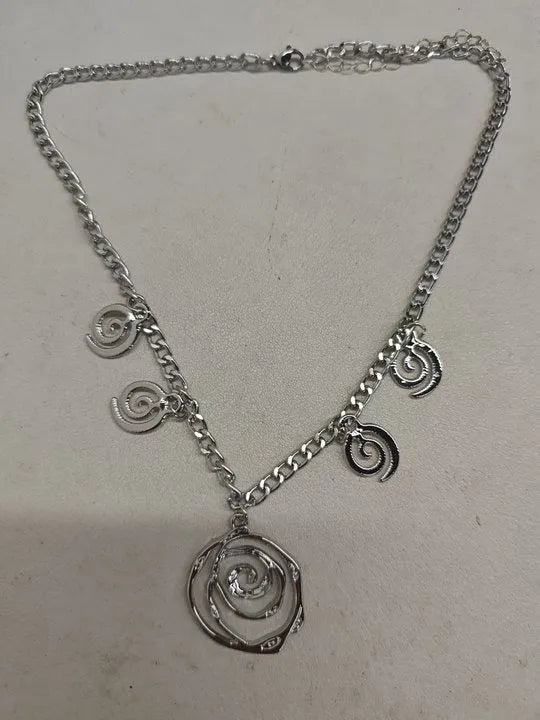 Spiral donut jewellery set showing necklace, bracelet and earrings in gold tone geometric circle design
