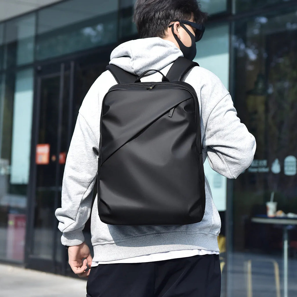 Waterproof large capacity PU backpack in black, blue, or grey with simple design