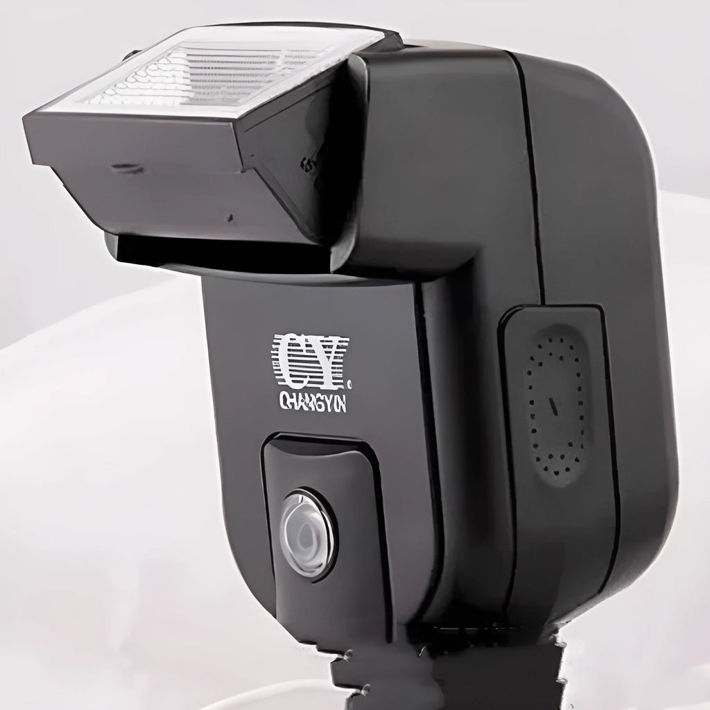 Compact silver hot shoe flash for SLR cameras with tilted head on a white background.