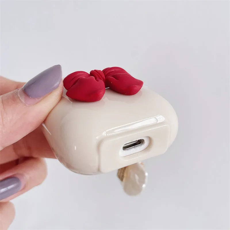 Beige red bow shell TPU AirPods case with clamshell opening design