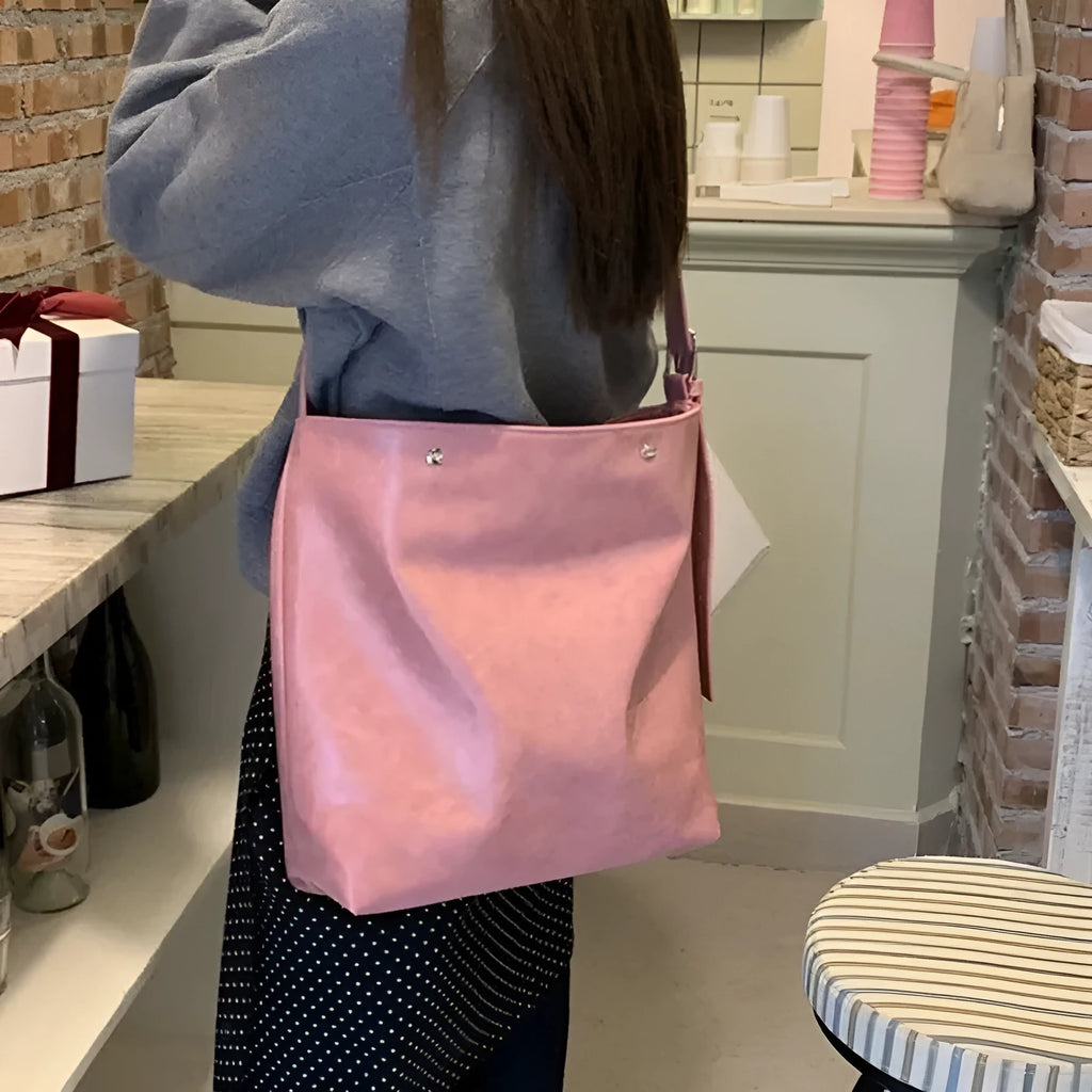 Pink and brown corduroy one-shoulder commuter bag with PU lining.