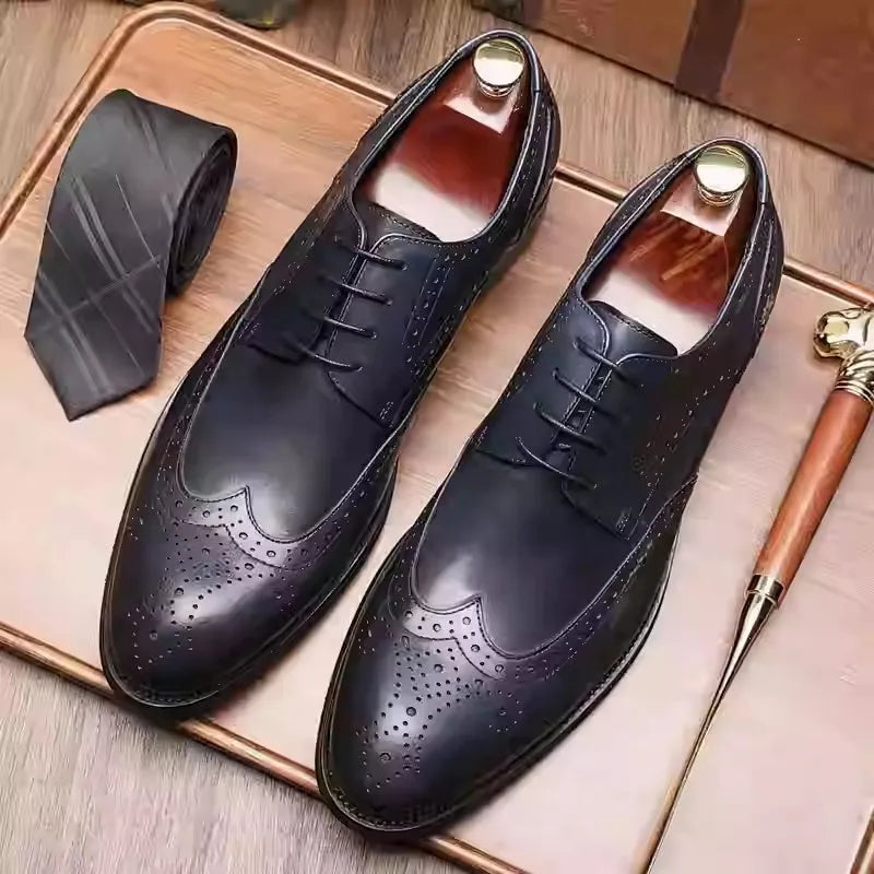 Men's burgundy leather brogue shoes with carved patterns, pointed toe, and low flat heel for formal occasions