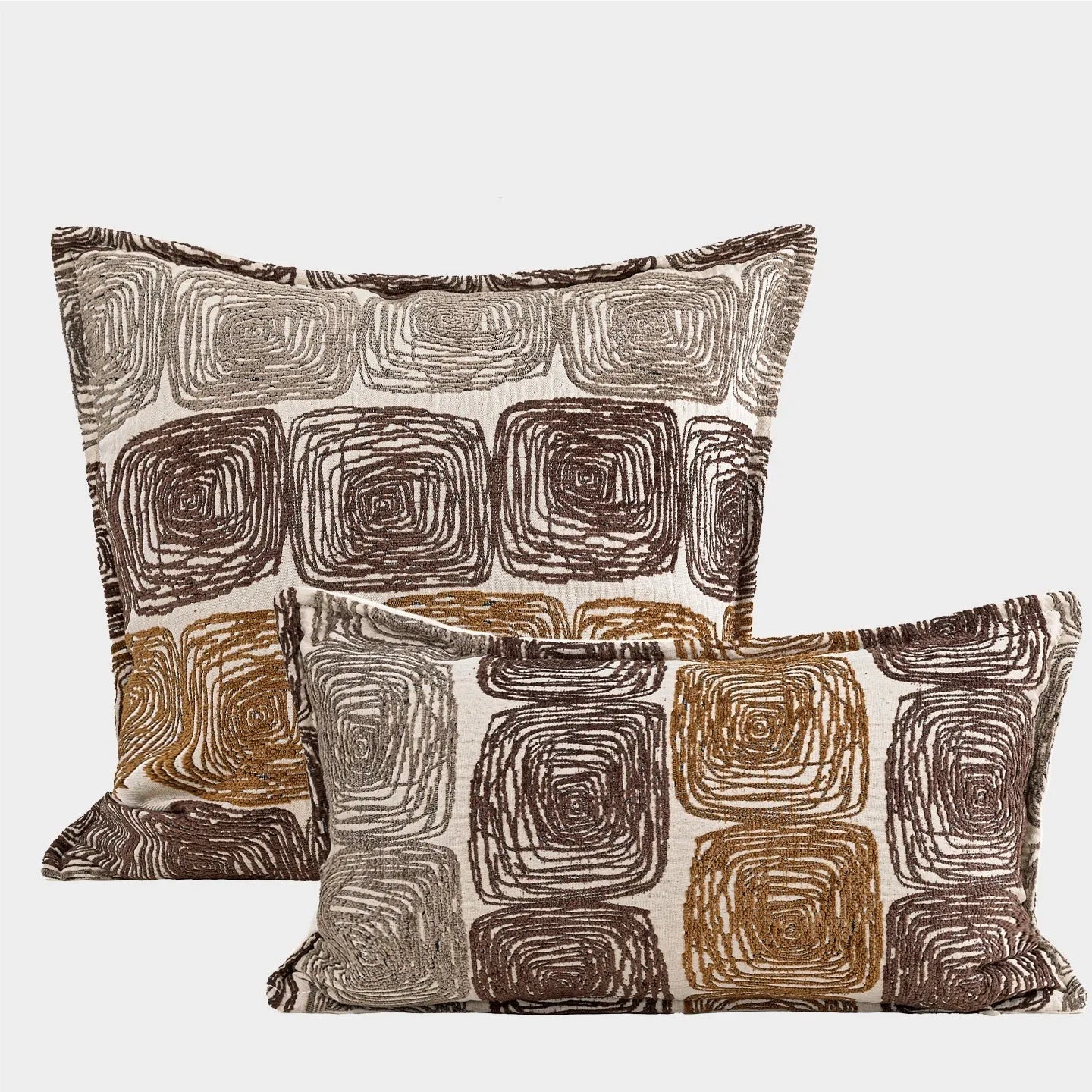 Cream and coffee-coloured abstract geometric coil pattern on a square pillow cover.