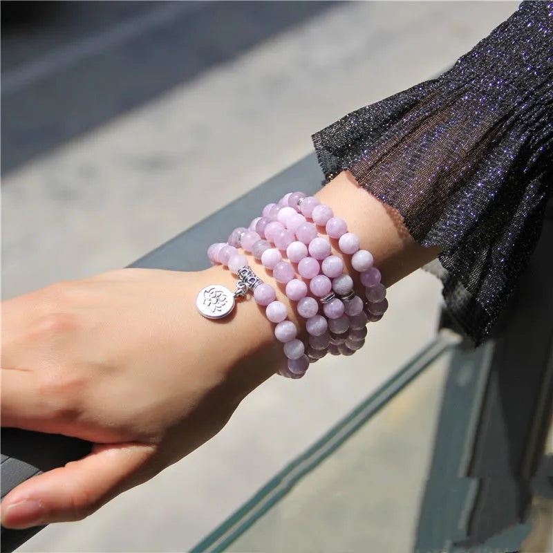 Natural stone ladies bracelet with geometric angel echeveria and lotus design on a wrist.