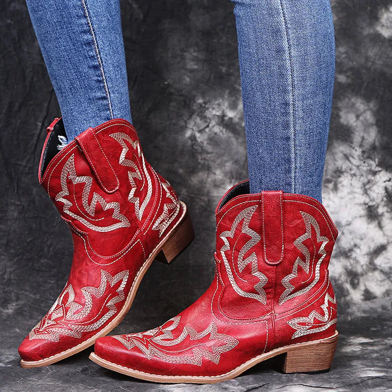Women's blue cowboy boot with embroidery detail on the side, low wedge heel, and pointed toe.