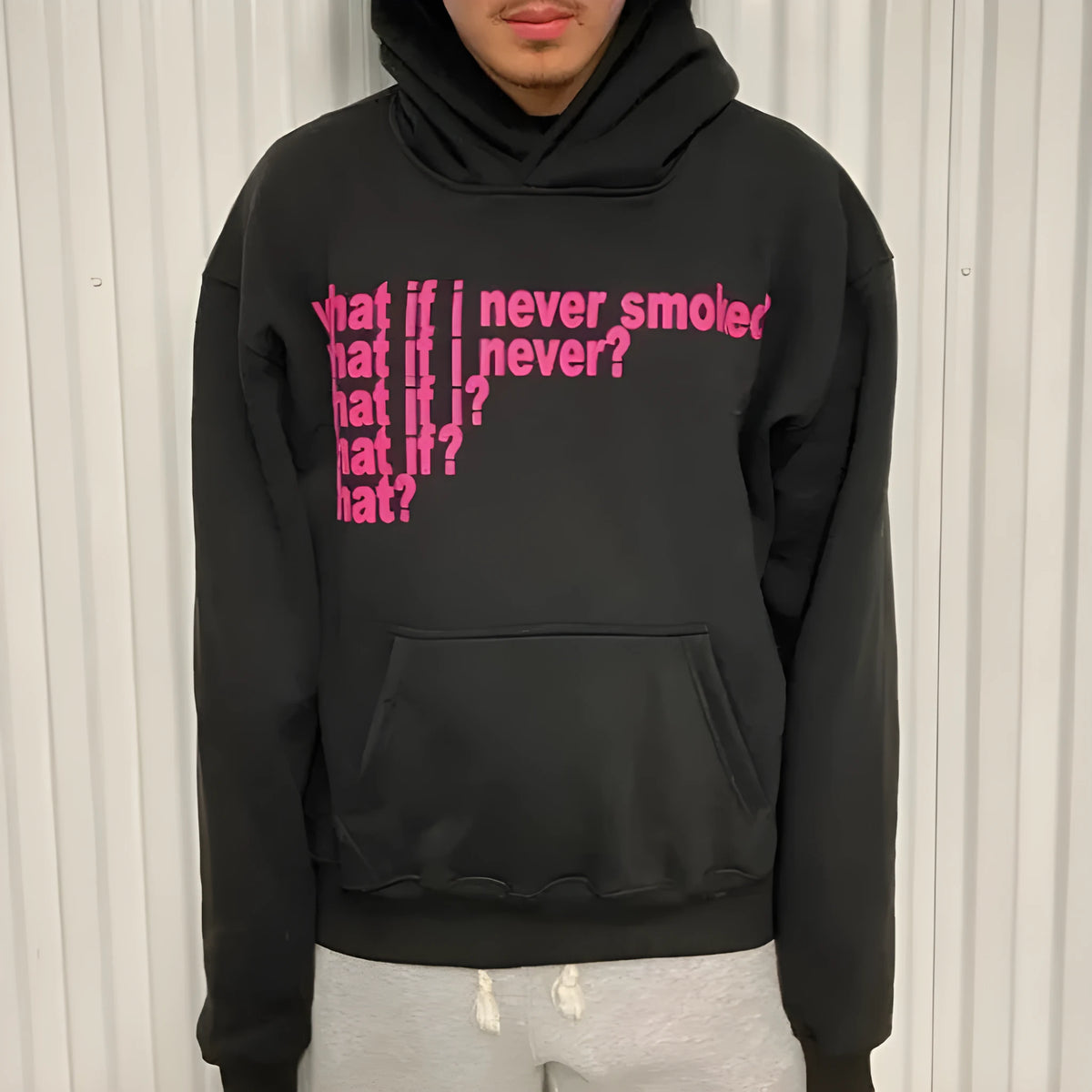 Black hooded sweatshirt with a white letter print graphic on the front.