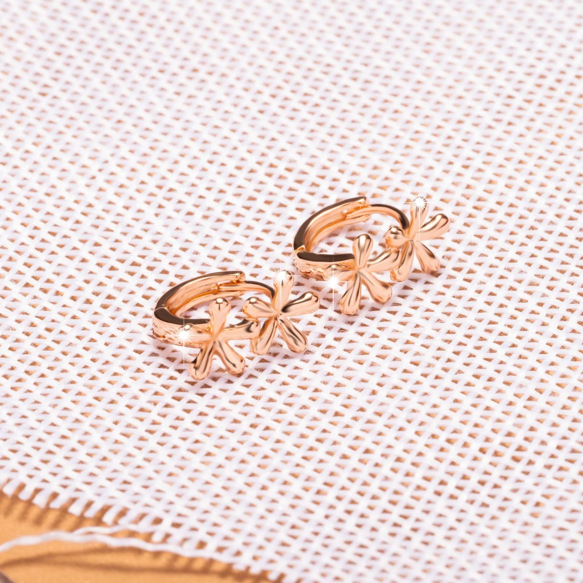 Rose gold circular earrings with waterdrop flower design and electroplated finish
