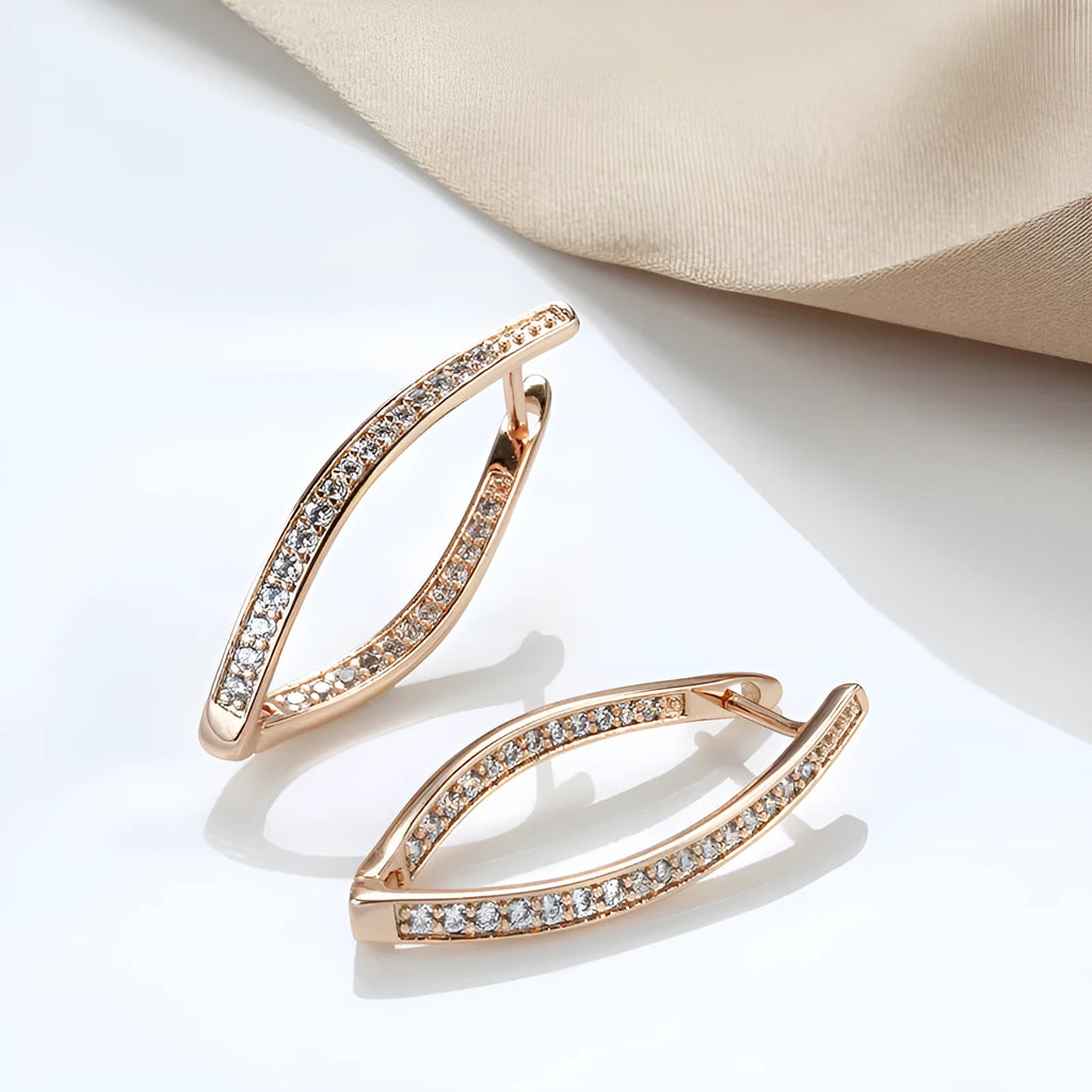 A pair of geometric drop earrings with a clear zircon stone and copper posts, colour H0493.