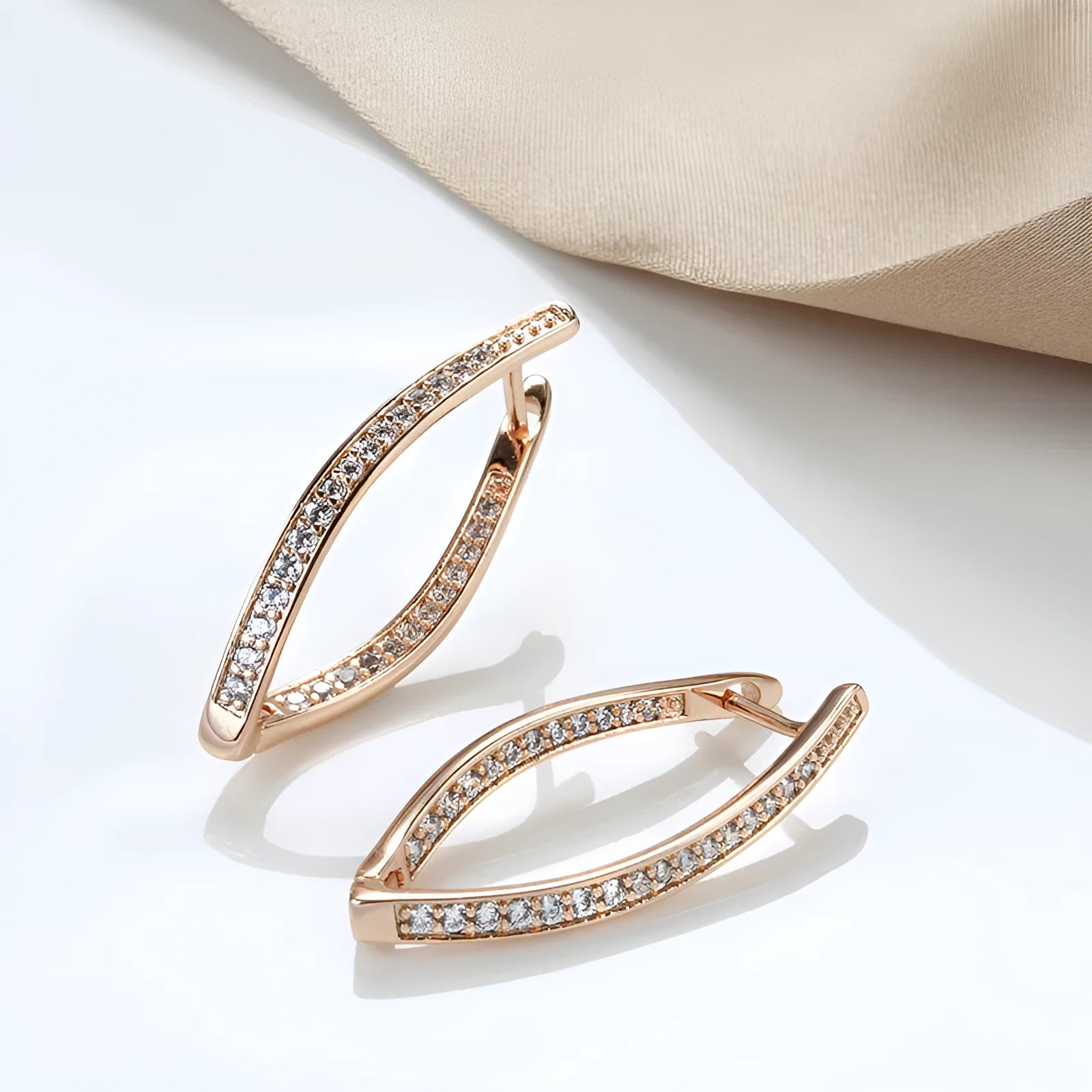A pair of geometric drop earrings with a clear zircon stone and copper posts, colour H0493.