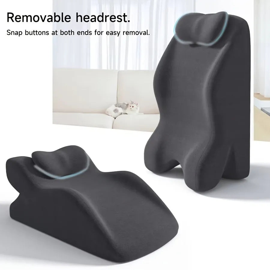 A flat stomach sleeper pillow shown on a bed, designed for prone sleeping and reading.