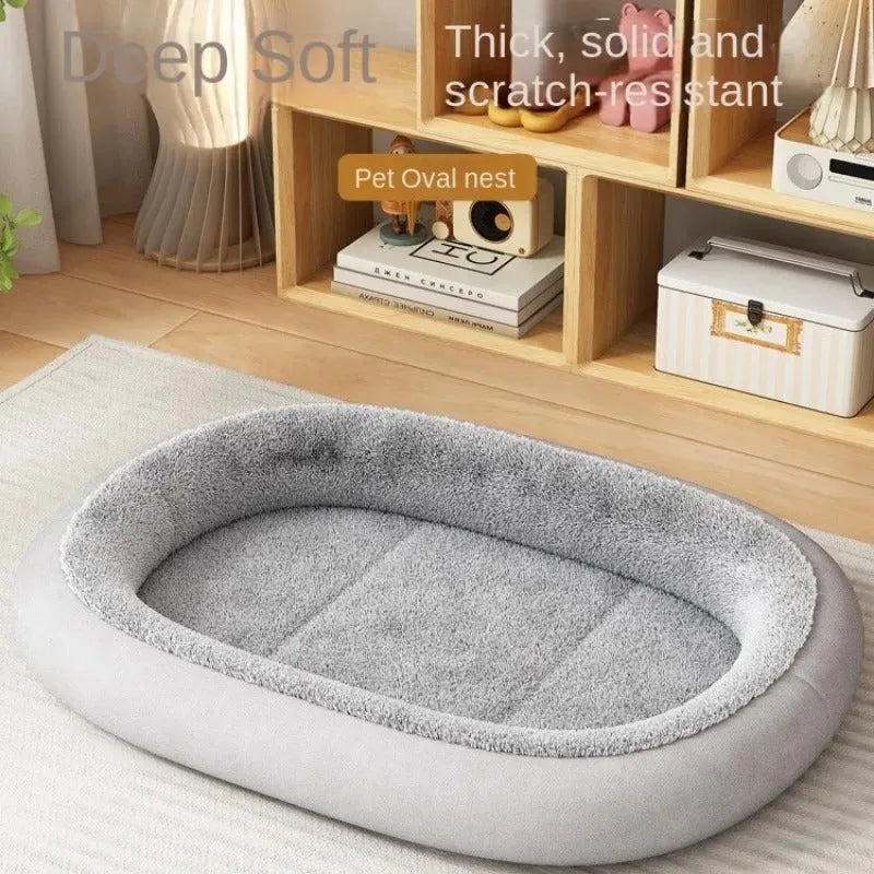 A grey thickened pet kennel with a fleece cover for a small dog resting inside on a wooden floor.