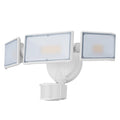 White outdoor LED security flood light with motion sensor mounted on a wall.