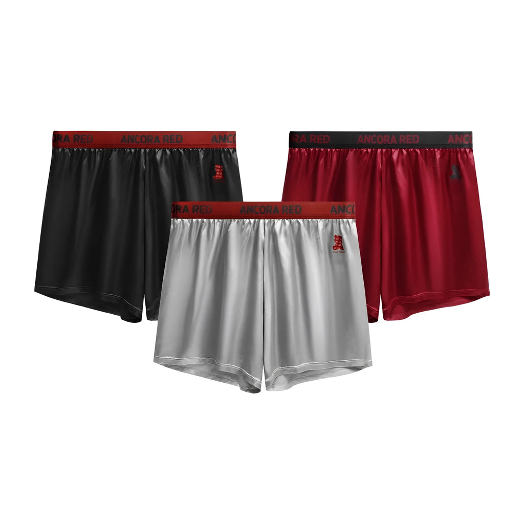 Men's solid colour boxer briefs in black on a mid-waist mannequin, showing knit polyester fabric.