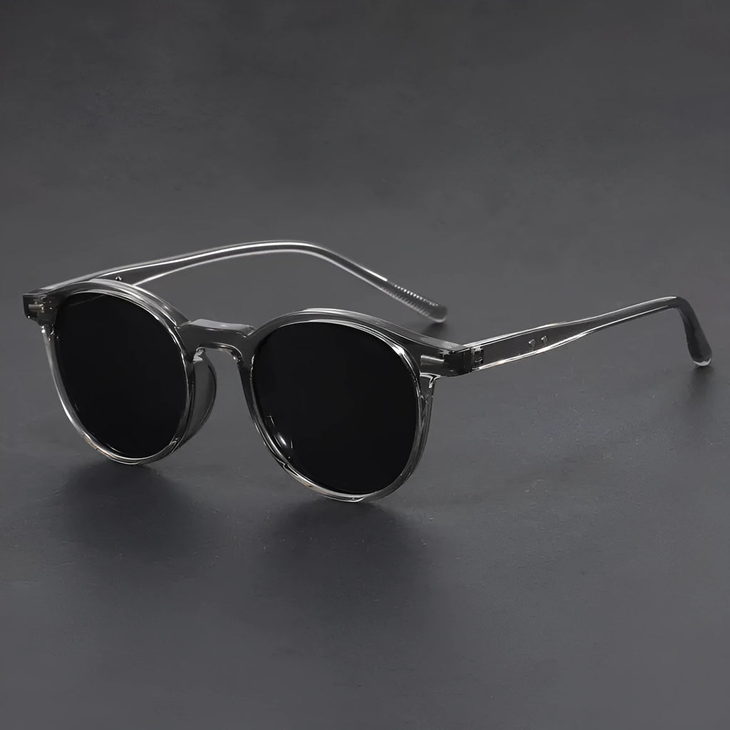 Retro round frame sunglasses with polarised grey lenses on a neutral background.