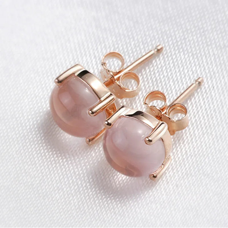 Rose gold drop-shaped stud earrings with synthetic ross quartz crystal inlay