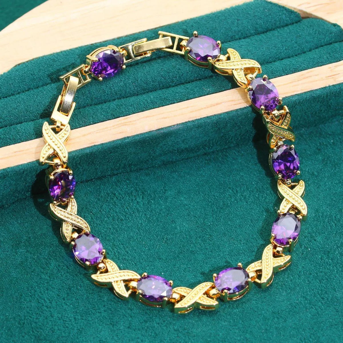 18k gold plated jewellery set with blue cubic zirconia stones showing necklace, earrings, ring, and bracelet