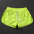 Men's loose polyester beach shorts in orange red, fluorescent green, or black colours