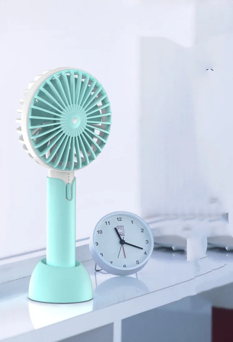 Blue portable USB handheld fan with three-speed control on desktop