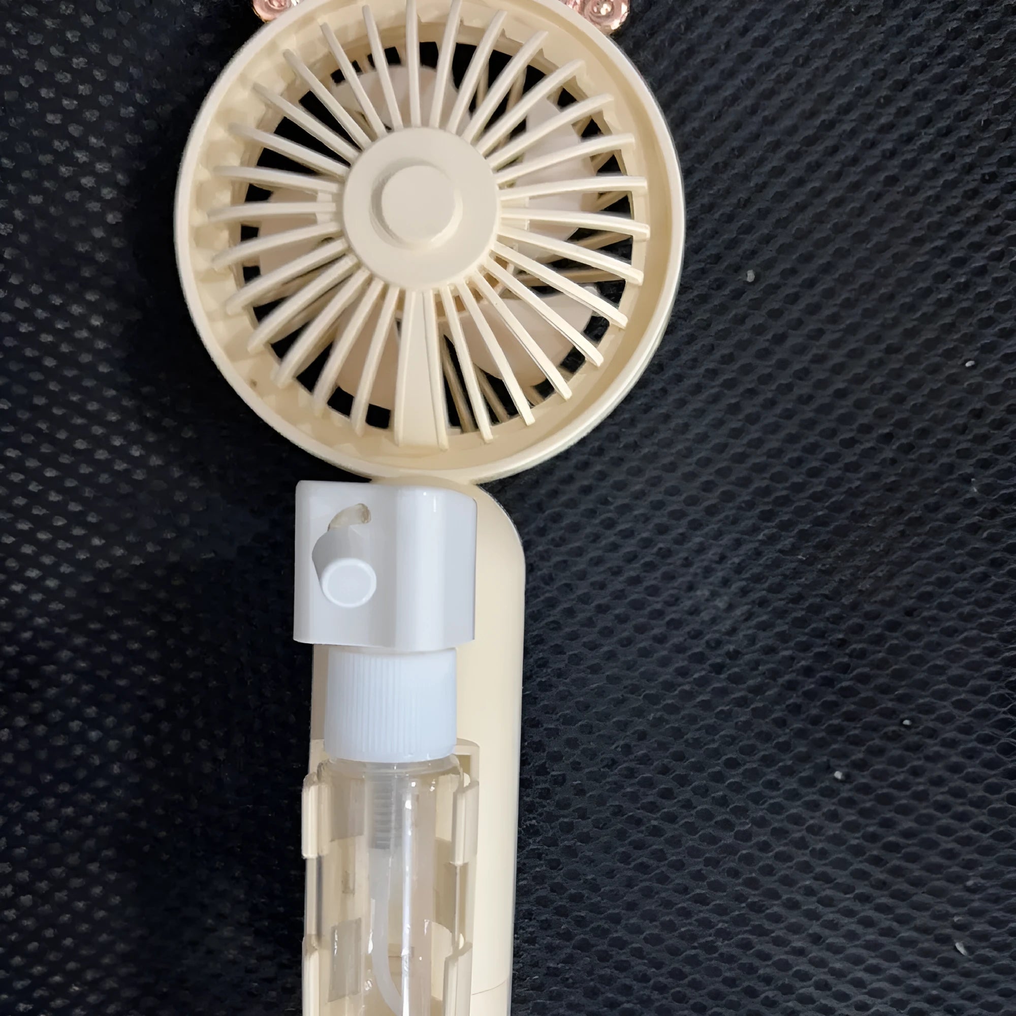 USB rechargeable plastic nozzle personal fan in apricot, blue, green, orange, or pink colour, showing compact size.