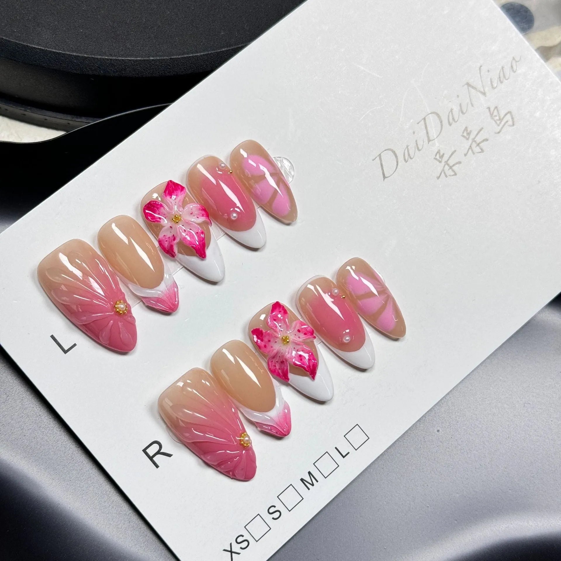 Set of plastic French style lily ice flower almond shaped nail armour capsules in XS, S, M, L sizes.