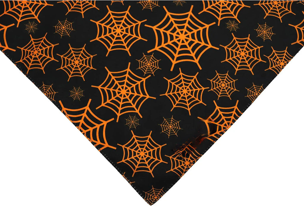Reversible Halloween dog bandana with pumpkin and spider web patterns in black and orange colours