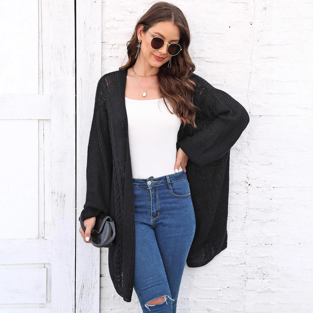 Women's loose fit acrylic sweater coat in a solid colour, shown in a casual setting.
